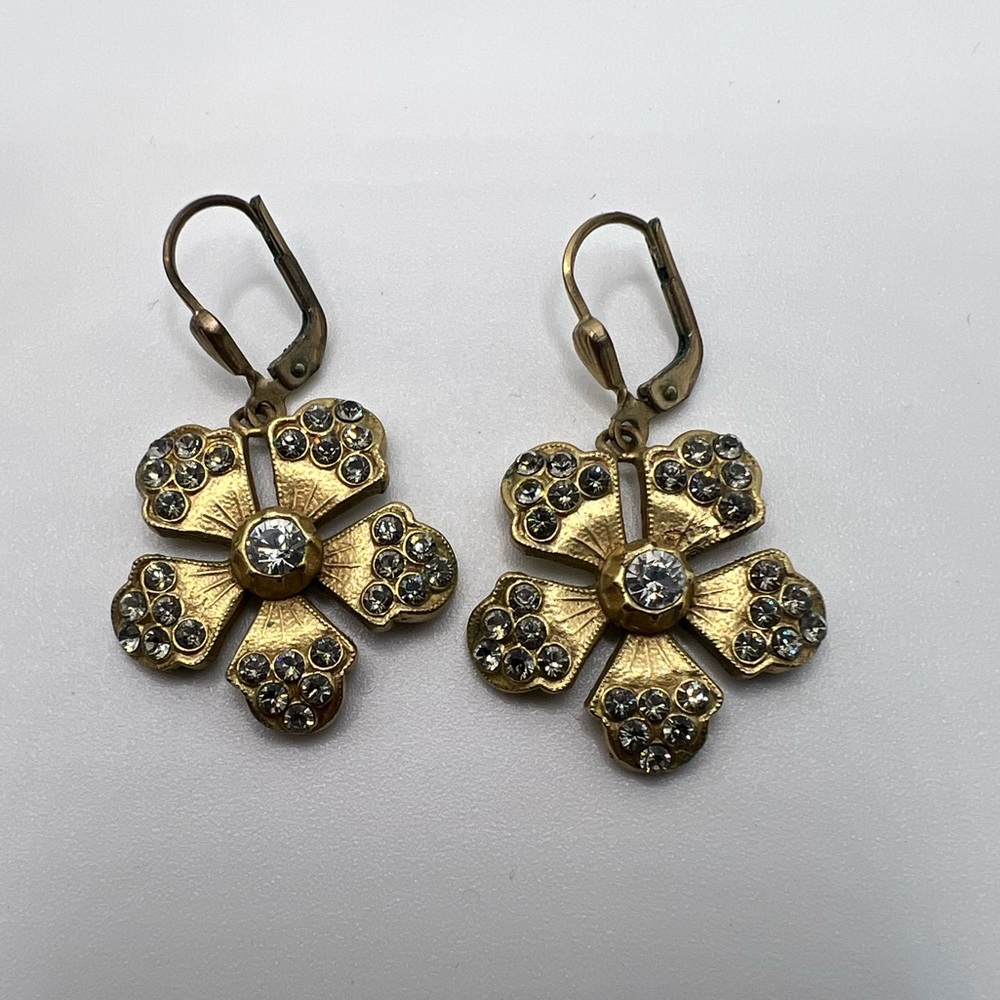 Gold and rhinestone flower earrings.